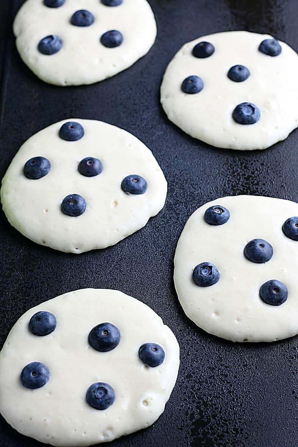 Start your morning off with a delicious batch of Blueberry Buttermilk Pancakes from scratch. This light and fluffy blueberry pancake recipe is perfect for blueberry season or all year round.
