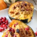 Roasted Acorn Squash with Cornbread Sausage Stuffing is a perfect recipe for Thanksgiving and fall. Fresh cranberries, cornbread and sausage round out this easy acorn squash recipe. This sausage stuffed acorn squash makes an easy fall main dish or delicious holiday side. Also, you'll learn how to cook acorn squash. Try this baked acorn squash recipe for dinner.