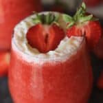 Cheers to Strawberry season. With just a few simple ingredients, you can make your own Strawberry Shortcake Daiquiris at home. Skip the mix and make fresh strawberry daiquiris at home using this easy recipe. It's the perfect slushy cocktail for cooling down in warmer weather! #strawberrydaiquiri #cocktails #slush