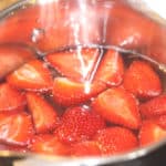 Cheers to Strawberry season. With just a few simple ingredients, you can make your own Strawberry Shortcake Daiquiris at home. Skip the mix and make fresh strawberry daiquiris at home using this easy recipe. It's the perfect slushy cocktail for cooling down in warmer weather! #strawberrydaiquiri #cocktails #slush