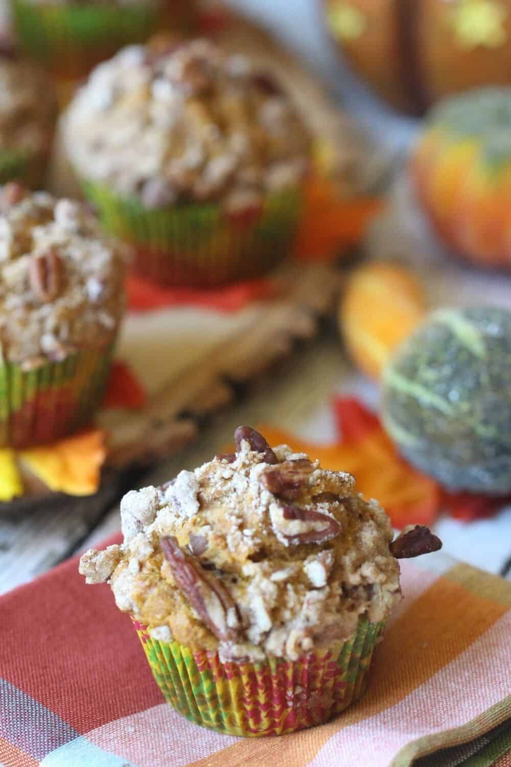 These Pumpkin Pecan Crunch Muffins combine a delicious pumpkin muffin with a crunchy pecan streusel topping. These pumpkin muffins are the perfect snack for any time of the day. #pumpkinmuffins #fallrecipe #muffinrecipe