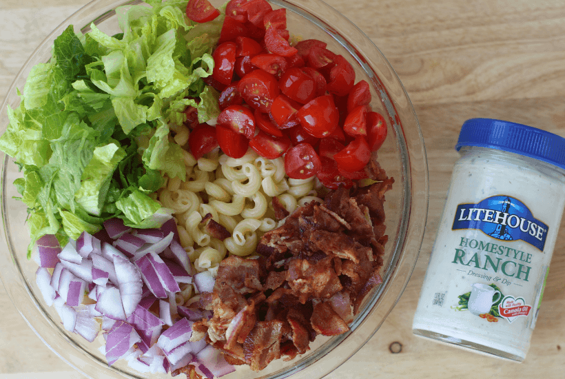 Everything is better with bacon! It's picnic season and this BLT Pasta Salad is the perfect summer salad recipe! This pasta salad recipe is filled with crispy bacon, fresh tomatoes and romaine. It is dressed with Litehouse Ranch Dressing. Save this kicked up macaroni salad recipe for your next backyard BBQ or picnic. #bltpastasalad #BLT #pastasalad #bacon #summersalad #macaronisalad