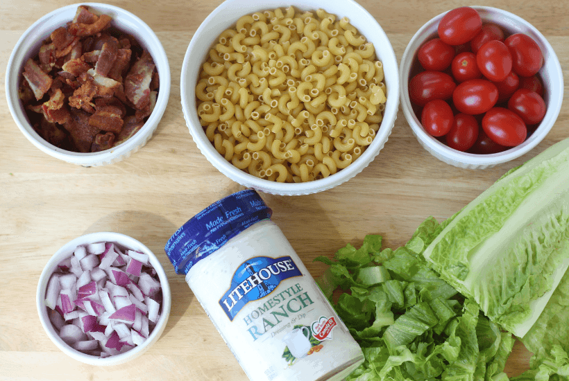 Everything is better with bacon! It's picnic season and this BLT Pasta Salad is the perfect summer salad recipe! This pasta salad recipe is filled with crispy bacon, fresh tomatoes and romaine. It is dressed with Litehouse Ranch Dressing. Save this kicked up macaroni salad recipe for your next backyard BBQ or picnic. #bltpastasalad #BLT #pastasalad #bacon #summersalad #macaronisalad