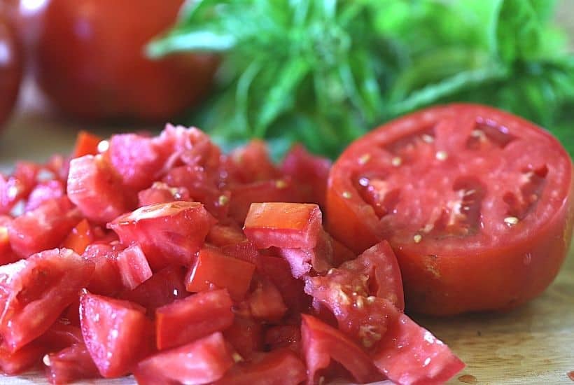 Garden fresh tomatoes, corn, and basil pair up to form the perfect trio in this Tomato Corn And Basil Salad! This easy summer salad recipe is delicious. This is also an easy make-ahead salad recipe you can serve at a party.