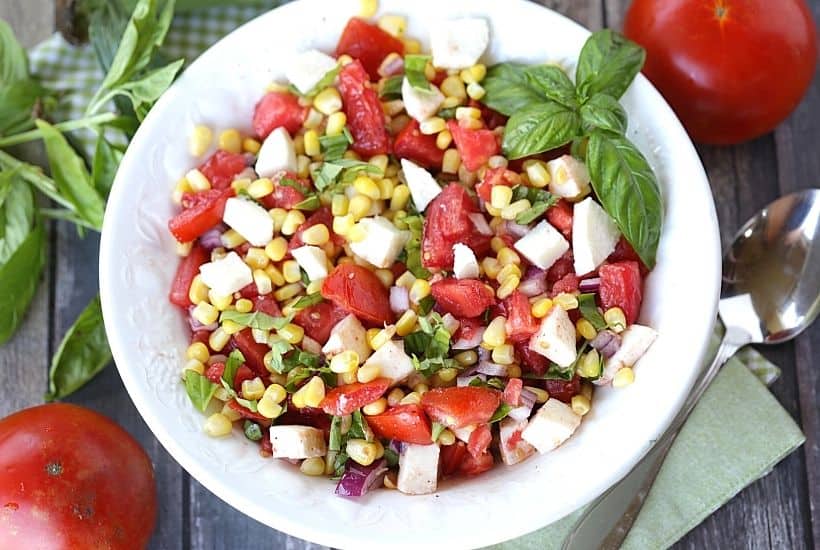 Garden fresh tomatoes, corn, and basil pair up to form the perfect trio in this Tomato Corn And Basil Salad! This easy summer salad recipe is delicious. This is also an easy make-ahead salad recipe you can serve at a party.
