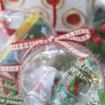 Gift the gift of lottery luck this holiday season with these fun New Jersey Lottery Ticket Christmas Ornaments. These DIY Christmas ornaments are easy to make. Grab some lottery ytickets and fill a plastic ornament. This easy Christmas craft takes only a few minutes to make. These ornaments are fun to hang on the Christmas Tree. Lottery Ticket ornaments make a great Christmas gift idea too.