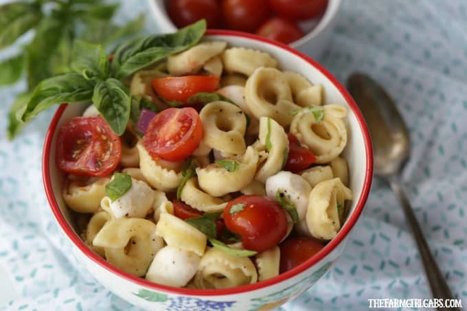 Turn pizza night into party night with this delicious Caprese Tortellini Salad. This recipe is the perfect quick side dish for a weeknight dinner or party.