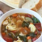 This classic Tuscan Chicken Soup will warm you up on a cold winter's day! This easy soup recipe is filled with hearty vegetables, chicken and tortellini. This Italian-style chicken soup is easy to prepare and is filled with spinach too. It can be easily prepared in a slow cooker, making it a delicious slow cooker chicken soup or an easy Instant Pot Soup recipe.