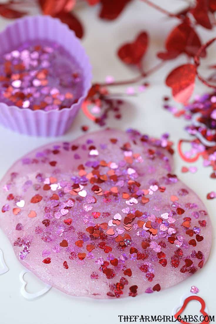 You and your kids will LOVE making this easy DIY Valentine's Day Slime project. This fun craft makes a great party favor too!