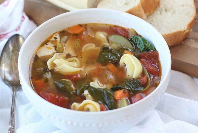 This classic Tuscan Chicken Soup will warm you up on a cold winter's day! This easy soup recipe is filled with hearty vegetables, chicken and tortellini. This Italian-style chicken soup is easy to prepare and is filled with spinach too. It can be easily prepared in a slow cooker, making it a delicious slow cooker chicken soup or an easy Instant Pot Soup recipe.