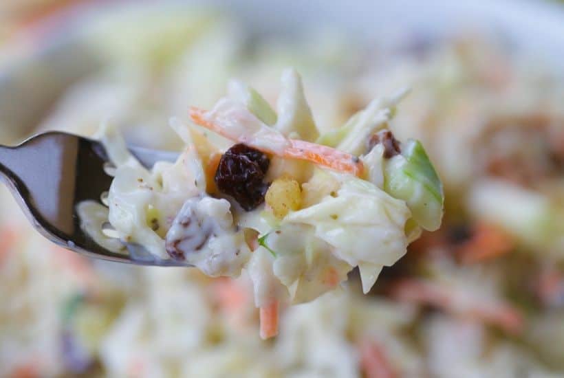 Coleslaw isn't just for picnics. Take your coleslaw to a new level with this tasty Apple Raisin Coleslaw. This southern coleslaw recipe is the perfect side dish to serve any time of year. Ready in just 10 minutes, this delicious coleslaw recipe is topped with a creamy homemade dressing. It's the perfect blend of sweet and savory. #coleslaw #easyrecipe #southerncoleslaw