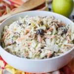 Coleslaw isn't just for picnics. Take your coleslaw to a new level with this tasty Apple Raisin Coleslaw. This southern coleslaw recipe is the perfect side dish to serve any time of year. Ready in just 10 minutes, this delicious coleslaw recipe is topped with a creamy homemade dressing. It's the perfect blend of sweet and savory. #coleslaw #easyrecipe #southerncoleslaw