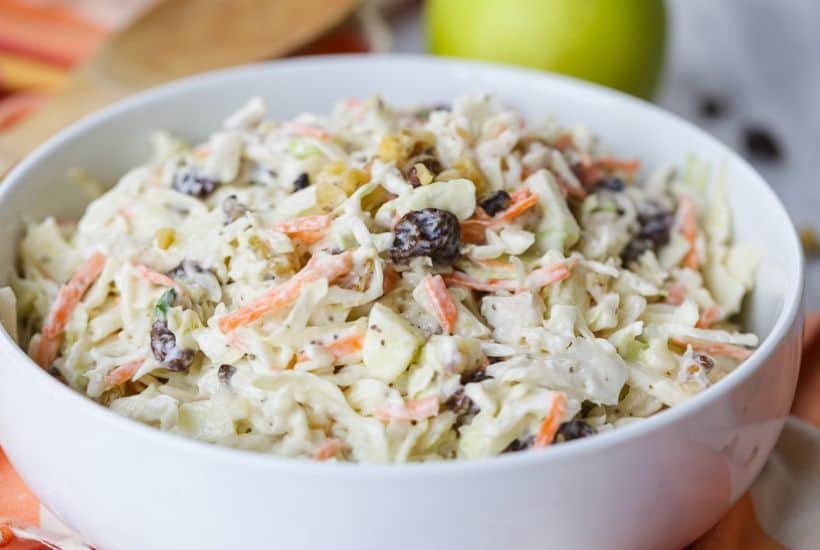Coleslaw isn't just for picnics. Take your coleslaw to a new level with this tasty Apple Raisin Coleslaw. This southern coleslaw recipe is the perfect side dish to serve any time of year. Ready in just 10 minutes, this delicious coleslaw recipe is topped with a creamy homemade dressing. It's the perfect blend of sweet and savory. #coleslaw #easyrecipe #southerncoleslaw