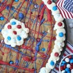 This festive Firecracker Cookie Cake recipe is the perfect dessert for your patriotic celebration! This easy chocolate chip cookie is decorated in red, white and blue and is a perfect recipe for the 4th of July, Memorial Day or Labor Day.