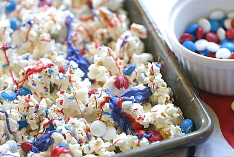 Salute the red, white and blue with this tasty Patriotic White Chocolate Popcorn. This easy popcorn recipe is perfect for a 4th of July Party or patriotic celebration.