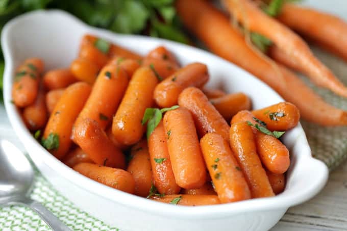 These Honey Glazed Carrots are a simple side dish to serve for any meal. They make a great holiday recipe for Thanksgiving and Easter too. #Carrots #SideDish #VegetableRecipe #Thanksgiving #HolidayRecipe