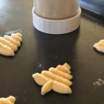 These classic Spritz Cookies are rich, buttery and a must-have cookie for Christmas. Rumor has it that they are Santa's favorite too. #SpritzCookies #ChrismtasCookies #CookieRecipe #holidaybaking #holidayrecipes #Christmascookieexchange #Christmascookierecipe