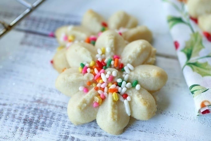 These classic Spritz Cookies are rich, buttery and a must-have cookie for Christmas. Rumor has it that they are Santa's favorite too. #SpritzCookies #ChrismtasCookies #CookieRecipe #holidaybaking #holidayrecipes #Christmascookieexchange #Christmascookierecipe