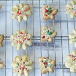 These classic Spritz Cookies are rich, buttery and a must-have cookie for Christmas. Rumor has it that they are Santa's favorite too. #SpritzCookies #ChrismtasCookies #CookieRecipe #holidaybaking #holidayrecipes #Christmascookieexchange #Christmascookierecipe