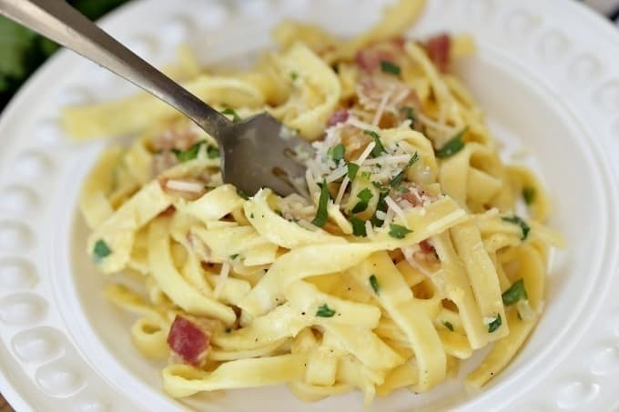 Eggs, bacon and parmesan team up to create an out of this world Pasta Carbonara. This easy recipe is perfect for a quick weeknight meal.