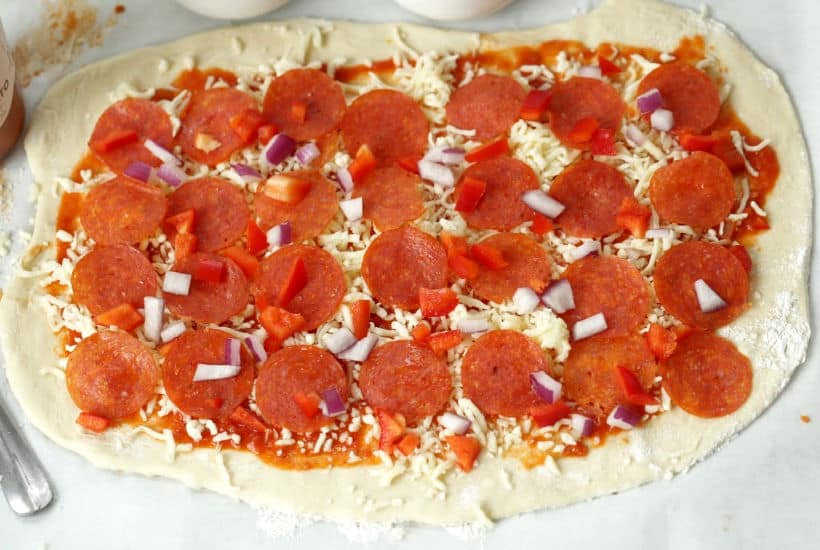 When you want to change up your normal pizza routine, try this easy Pepperoni Pizza Pinwheels recipe instead. They are a perfect snack or meal option. #Ad #LivenUpYourMeal #Mezzetta #MezzettaSauce #KetoLife #PizzaRecipe #Pinwheels