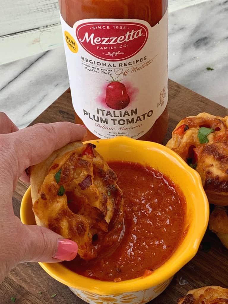 When you want to change up your normal pizza routine, try this easy Pepperoni Pizza Pinwheels recipe instead. They are a perfect snack or meal option. #Ad #LivenUpYourMeal #Mezzetta #MezzettaSauce #KetoLife #PizzaRecipe #Pinwheels
