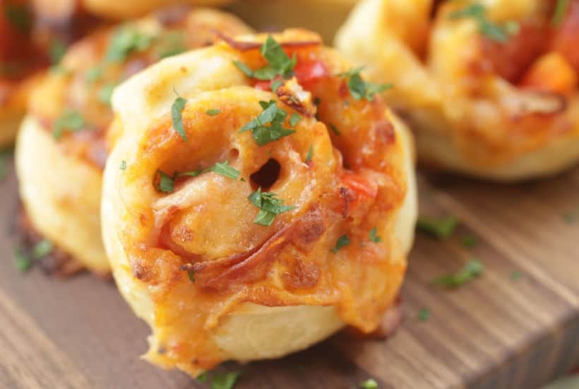 When you want to change up your normal pizza routine, try this easy Pepperoni Pizza Pinwheels recipe instead. They are a perfect snack or meal option. #Ad #LivenUpYourMeal #Mezzetta #MezzettaSauce #KetoLife #PizzaRecipe #Pinwheels