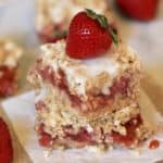 These Strawberry Rhubarb Oatmeal Bars are the perfect summer dessert! Strawberries and rhubarb pair perfectly together in this tasty bar recipe. This strawberry rhubarb bar recipe has a delicious oatmeal cookie topping.