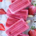 Keep cool this summer with these healthy Strawberries and Cream Popsicles.  Kids young and old will love this healthy summer snack recipe. These strawberry frozen treats won't last long. #popsicles #healthypopsicles #strawberrypopsicles #popsiclerecipe