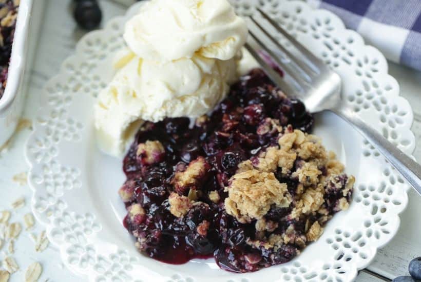 It's blueberry season! This easy blueberry crisp recipe it the perfect way to celebrate. This fruit crisp is a super simple summer dessert and perfect with a dollop of ice cream. #blueberrycrisp #blueberryrecipe #summerdessert