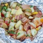 Fire up the grill and make this Potato And Bacon Foil Packets recipe. This easy grilled side dish is a perfect summer recipe or camping recipe. And it has bacon in it! #foilpackets #potatoandbaconfoilpacket #campingrecipe #grillingrecipe #Ad #BTBGrillingRecipes #IC