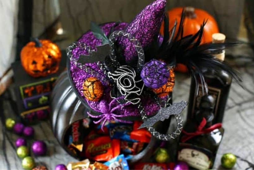 This adorably spellbinding DIY Witch Pumpkin Candy Holder is the perfect place to store your Halloween Candy Stash. #halloweencraft #pumpkincarving #pumpkincraft