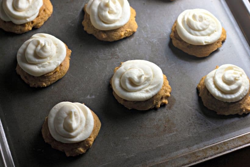 These Bakery Style Soft Pumpkin Cookies are soft and mildly sweet with just the right amount of pumpkin spice. The cream cheese icing is the perfect topping make this pumpkin cookie recipe a perfect fall treat. #pumpkincookies #pumpkinrecipe #falldessert #cookierecipe