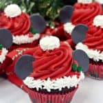 Make this Christmas a Disney Christmas. These adorable Mickey Mouse Santa Cupcakes are the perfect holiday Disney snack to celebrate Christmas. This Disney dessert is so easy and festive. Add a cute Mickey Santa hat to these decorated Christmas cupcakes. #disneysnack #christmascupake #disneyfood