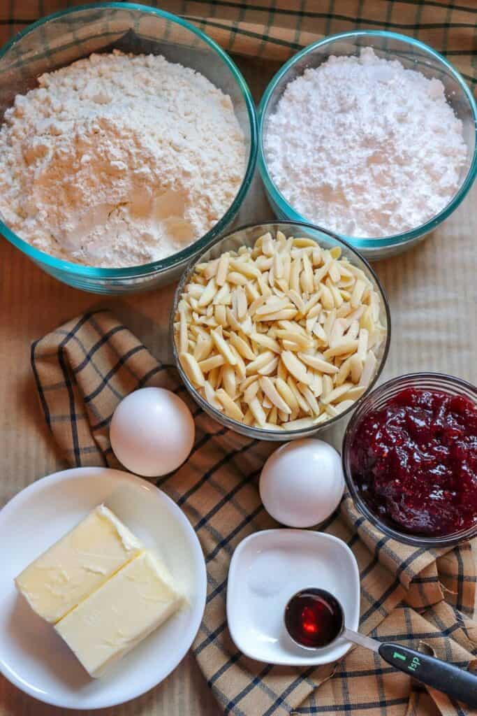 This Classic Linzer Cookies recipe will totally be your jam (no pun intended). Win your Christmas Cookie Swap with this delicious cookie recipe. This traditional Linzer sandwich cookie recipe is full of buttery almond flavor and filled with sweet raspberry jam. #chrismtascookie #cookieswap #linzercookies