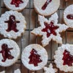 This Classic Linzer Cookies recipe will totally be your jam (no pun intended). Win your Christmas Cookie Swap with this delicious cookie recipe. This traditional Linzer sandwich cookie recipe is full of buttery almond flavor and filled with sweet raspberry jam. #chrismtascookie #cookieswap #linzercookies