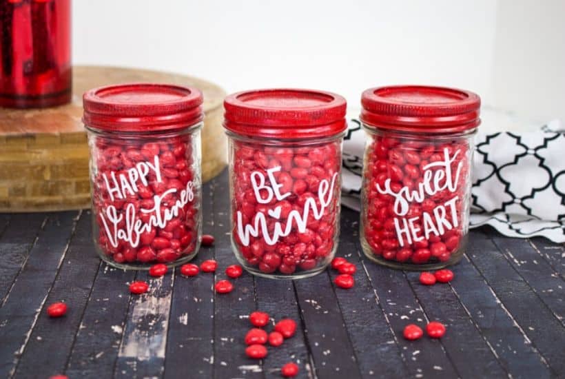 Share some sweetness this Valentine's Day. These Cricut Valentine Candy Mason Jars are a great gift idea for teachers, family and friends. This is an easy Valentine Craft idea to make with your Cricut Machine. This Cricut craft project is a perfect way to celebrate Valentine's Day. #cricutcraft #masonjars #valentinesday #valentinecraft