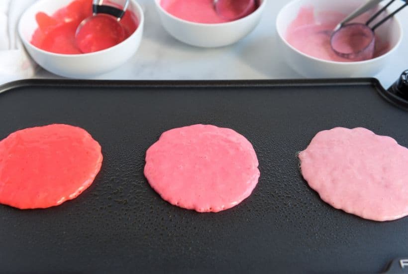 These Pink Ombre Pancakes are the perfect homemade Valentine's Day Pancake Recipe. Your family will love these light and fluffy pancakes. Share some love and make easy pancake recipe can be served all year long. #valentinesdaypancakes #ombrepancakes