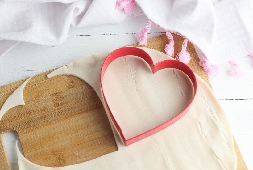 These Heart-Shaped Cherry Hand Pies are the perfect snack. Each hand pie is filled with sweet cherry pie filling sandwiched in between a flaky pie crust, then baked to perfection.