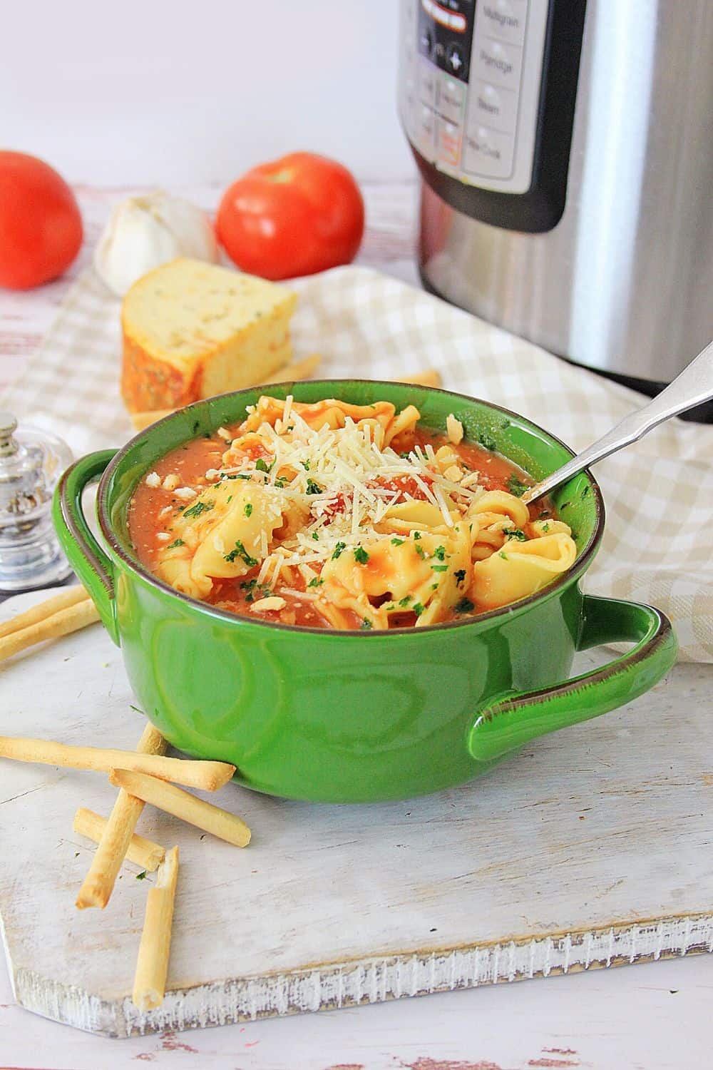 Warm yourself up with a bowl of this Instant Pot Chicken Parmesan Soup. This easy instant pot soup is a delicious comfort food recipe.