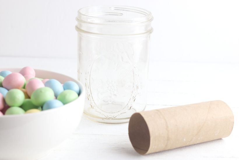 Add a touch of spring to your dining table. This easy Easter Candy Mason Jar Flower Vase is so easy to create. Grab so Easter candy and a mason jar and start crafting. You can make this easy holiday craft in just minutes. #eastercraft #holidaycraft