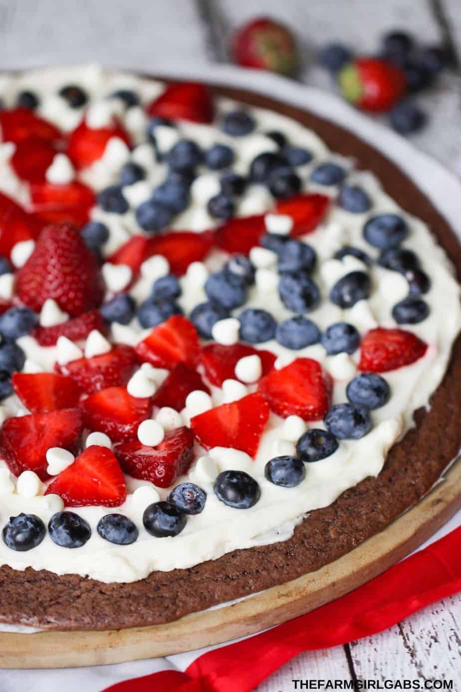 This Star-Spangled Brownie Pizza is perfect for any patriotic celebration. Bring this easy red, white and blue dessert recipe to your July 4th picnic. Your guests will love this decadent chocolate brownie recipe.