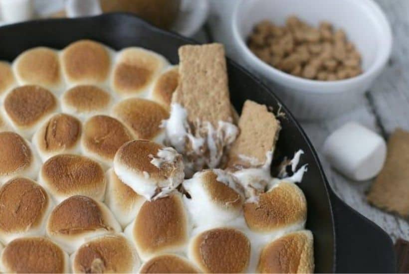 Chocolate Peanut Butter Skillet S'mores are an updated twist of the campfire classic s'mores recipe. This recipe has the perfect amount of chocolate and peanut butter. If you want all the delicious flavor of s'mores without the campfire, then you need to make this Chocolate Peanut Butter Skillet S'mores recipe. It is the perfect camping recipe to make indoors.