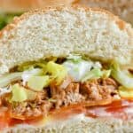 Looking for an easy weeknight meal? These Shredded BBQ Chicken Sandwiches are a delicious solution. Your family will love these barbecue chicken sandwiches. This easy sandwich recipe is great to serve at a party, football tailgate or game day celebration.