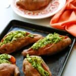 Enjoy a dairy-free and flavorful dish when preparing the Pesto Chicken Stuffed Sweet Potatoes. You can prepare this Whole 30 recipe in less than two hours. You will love how easy this sweet potato recipe is to make. This baked sweet potatoes recipe is so delicious.