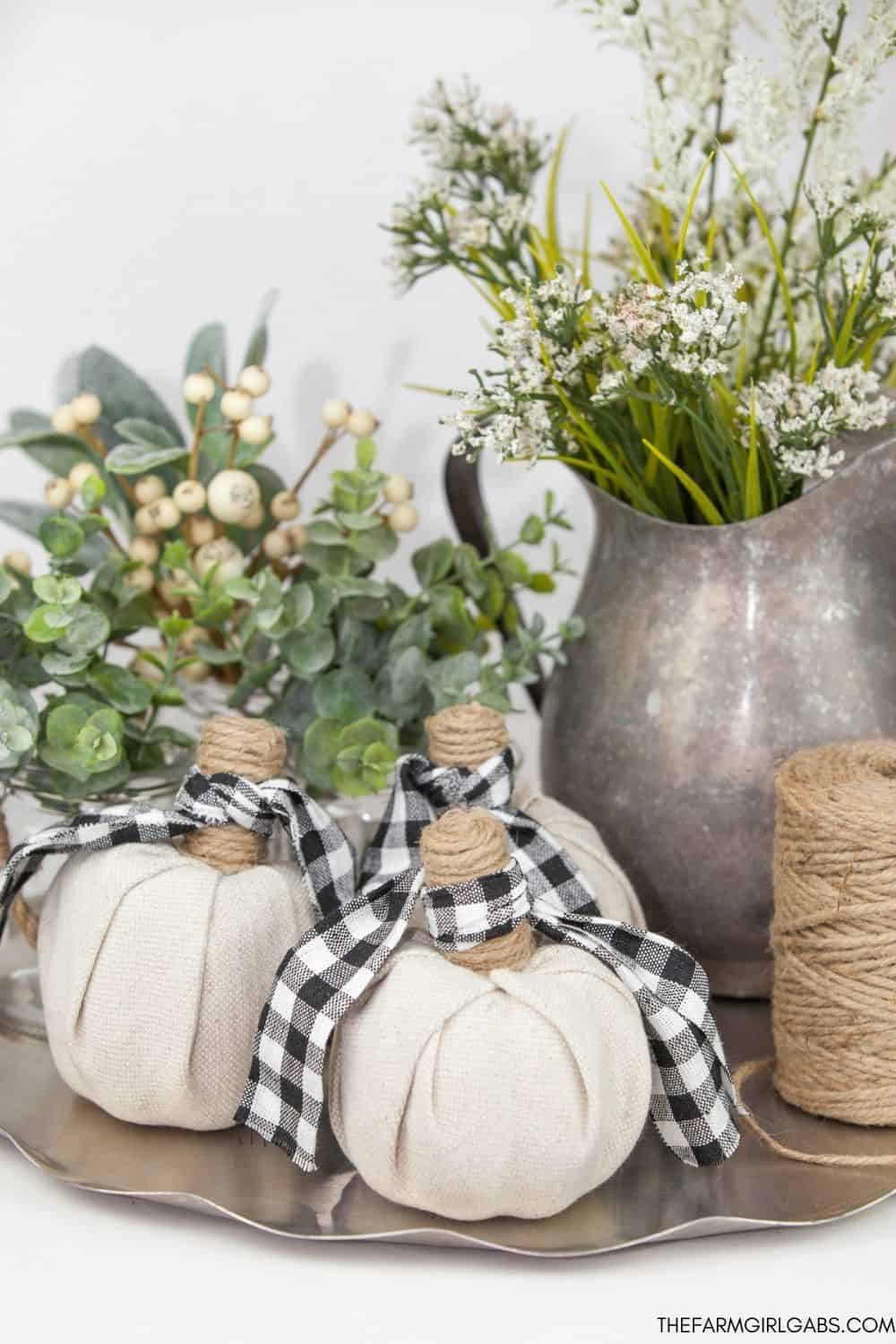 Create your own farmhouse style vibe this fall. These DIY Farmhouse Style Fabric Pumpkins are easy and so pretty to display. These farmhouse fabric pumpkins will be the perfect fall centerpiece for your farmhouse look.