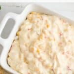 This Cheesy Slow Cooker Fiesta Corn Dip is a creamy, cheesy dip recipe that's perfect for any party. It's great for tailgating, too!