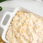This Cheesy Slow Cooker Fiesta Corn Dip is a creamy, cheesy dip recipe that's perfect for any party. It's great for tailgating, too!