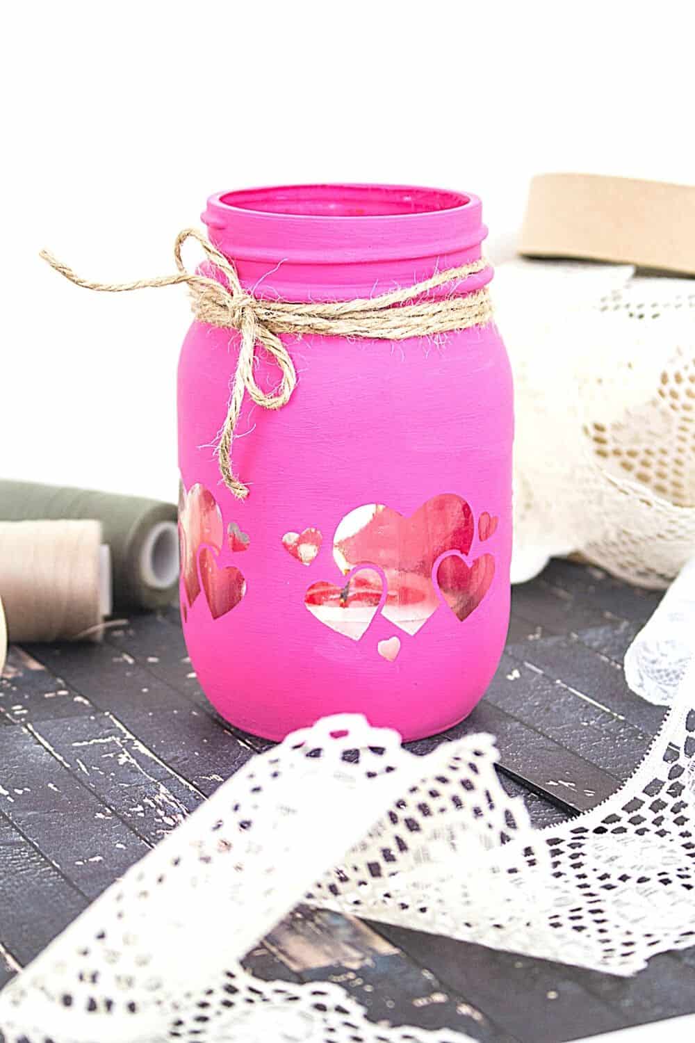 Grab some chalk paint and transform a mason jar into these Painted Mason Jar Valentine Lantern. This is an easy DIY Valentine's Day craft. Easy cricut craft project.