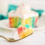 Make a colorful, moist, and utterly delicious cake within minutes with this Rainbow Poke Cake recipe. It is full of flavor and plenty of fun colors, including shades of pink, blue, and yellow!